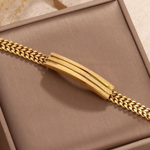 Close-up of gold-plated stainless steel curb chain bracelet with frosted metal plate