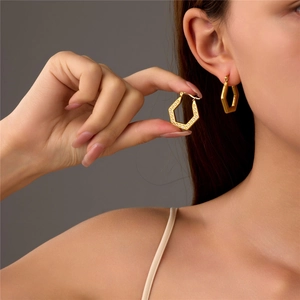Elegant geometric hexagonal gold earrings with zircon pave and polished metal finish