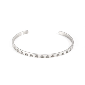 Macro shot of silver cuff bracelet with continuous geometric cubic zirconia pave settings