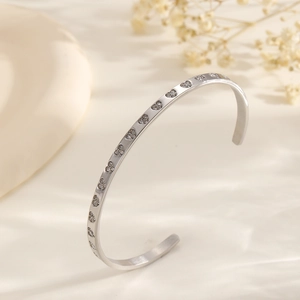Elegant silver stainless steel open bangle with heart patterns and zircon stones