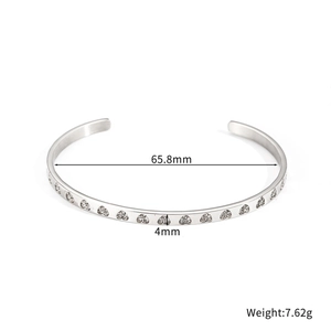 Detail shot of a 4mm silver geometric cuff bracelet with heart stones and 65.8mm inner diameter