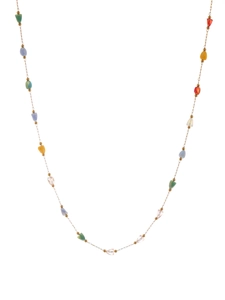 Detailed close-up of a slim gold chain necklace with faceted colorful geometric beads