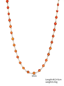 Detail of 6mm orange glass stone necklace with dimensions 46.5+5cm on white background