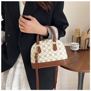 Brown and beige shell handbag featuring geometric floral prints and adjustable strap