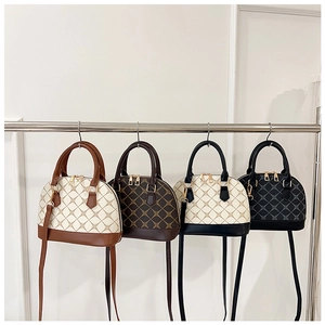 Four vintage shell handbags in various colors featuring grid patterns and gold hardware