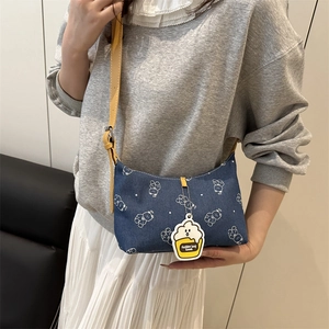 Denim shoulder bag with white bear patterns and a yellow adjustable strap for women