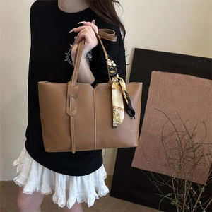 Vintage brown leather tote bag with white stitching and decorative silk scarf handle