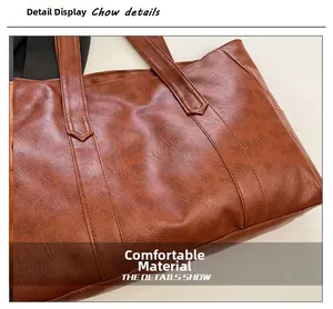 Close-up of brown vintage textured leather tote bag showing high-quality stitching