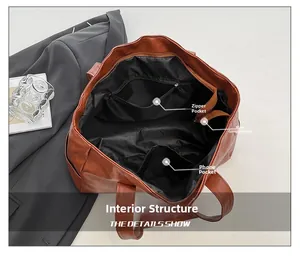 Detailed interior of brown leather tote bag showing zipper pocket and main compartment