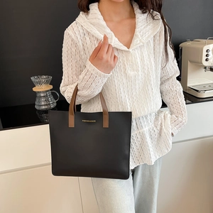 Bolso tote negro de gran capacidad con asas de cuero marrón y letras doradas de moda