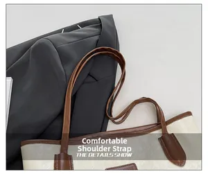 Detail of comfortable brown leather strap and houndstooth fabric on tote bag