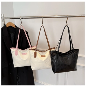 Detailed display of houndstooth textured tote bags in black, pink and brown trim colors