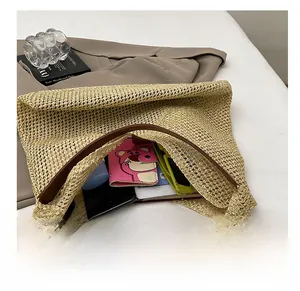 Detail of hand-woven straw tote showing spacious interior for wallet and sunglasses