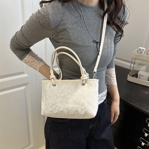 Chic white lace crossbody bag featuring floral embroidery and butterfly accents