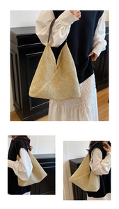 Detailed view of woven straw tote bag with premium leather shoulder strap and texture