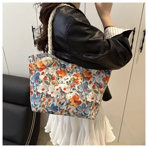 Close-up of floral tote bag with 3D flower patterns and sturdy cotton rope handles
