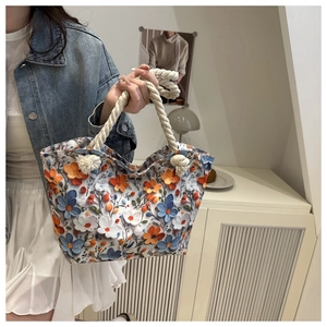 Detail of canvas tote bag with 3D floral print and decorative thick rope handles