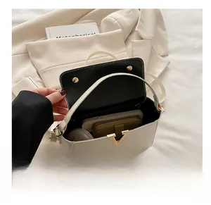 Interior view showing the storage capacity of the white patent leather handbag