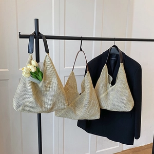Three woven straw shoulder bags in beige with leather straps for summer beach vacations