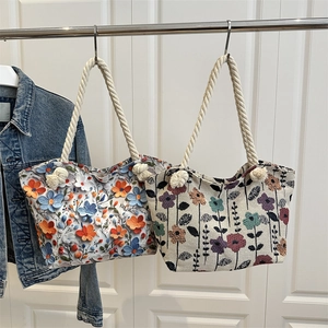 Floral tote bags with 3D embroidery and cotton rope handles on a white door backdrop