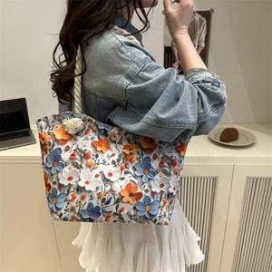 Floral textured tote bag with thick cotton rope handles shown on model in modern setting
