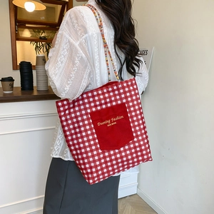 Red and white checkered canvas tote bag with front pocket and colorful woven straps