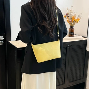 Sac seau minimaliste jaune vif en cuir avec bandoulière et boucles dorées chic