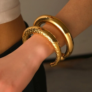 Polished gold geometric C-shaped open bracelet set with smooth and hammered textures