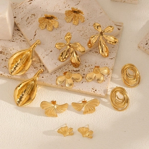 Golden flower earrings and organic metal pendants set with textured brushed finish