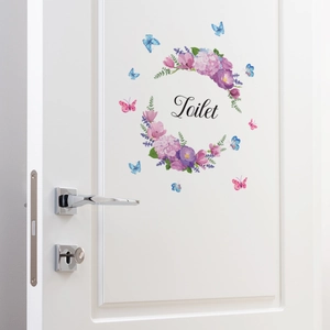 Floral wreath wall decal with butterflies and Toilet lettering on a white door