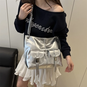 Metallic silver Y2K style tote bag with decorative straps and front flap pockets