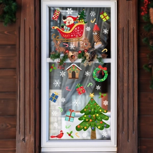Gros plan d'autocollants statiques double face Père Noël et traîneau sur vitre en verre