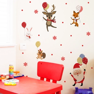 Christmas wall decal set with Santa Claus and cartoon animals on a white festive wall