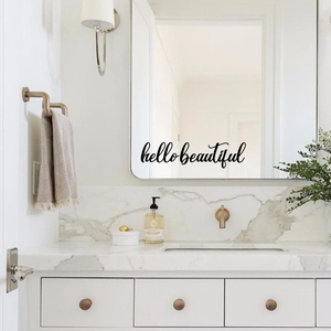 Detail of hello beautiful black vinyl wall decal on a modern bathroom mirror