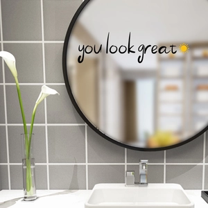 Self-adhesive you look great wall decal with sun icon on a round bathroom mirror