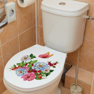 Floral toilet lid decal featuring colorful flowers and a butterfly on a white surface