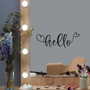 Detail of hello vinyl wall sticker with heart lines on a lit vanity mirror