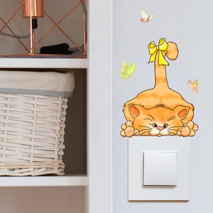 Detailed view of luminous cat wall sticker with butterflies above light switch