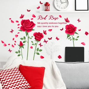 Detail of red rose wall decals with butterflies and romantic script on a white wall