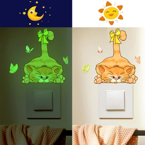 Luminous cat switch wall sticker showing green glow effect in darkness and daytime look