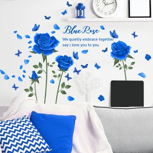 Detail of blue rose wall stickers with butterfly accents and romantic English text