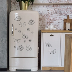 Minimalist hand-drawn fruit wall stickers applied on a vintage cream refrigerator surface