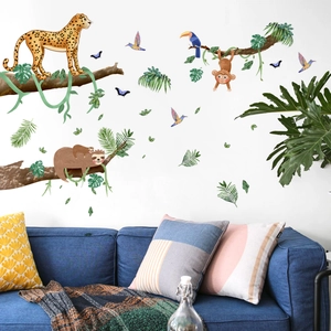 Jungle wall sticker with cartoon leopard, monkey, and tropical leaves in a living room