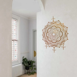 Detail of dark brown mandala wall sticker on a white corridor wall in a modern home