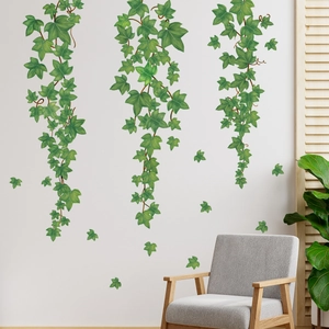 Detailed view of green ivy vine wall decals displayed on a clean white living room wall