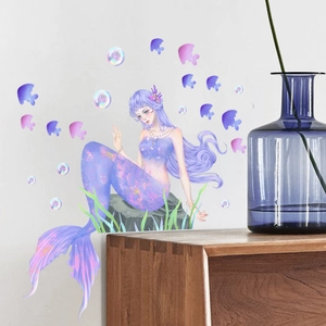 Luminous mermaid wall sticker with fish and bubbles on a white wall in a home setting