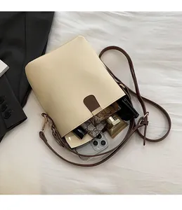 Top view of cream bucket bag interior showing spacious capacity for phone and perfume
