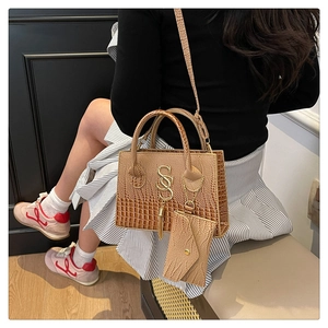 Caramel crocodile texture handbag and mini pouch set shown on model in modern room