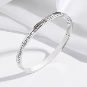 Silver stainless steel bangle with Roman numeral engravings and sparkling crystals