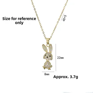 Close-up of a gold rabbit pendant necklace with sparkling rhinestones and black gem eyes